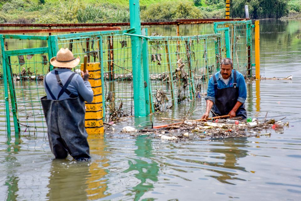 Workers clearing debris from floodwater