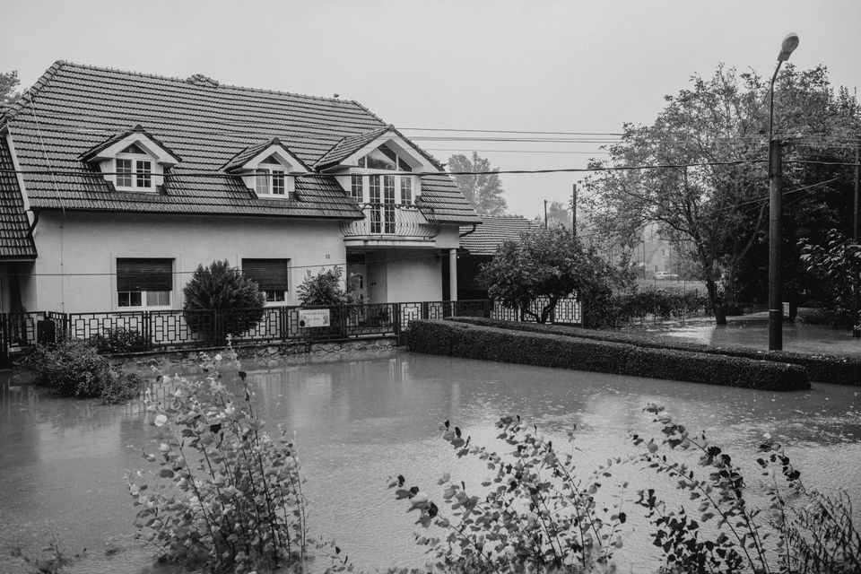 Flooded residential street during heavy rain