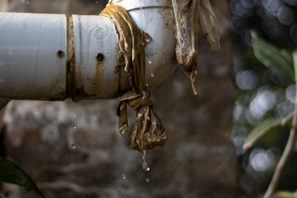 Leaking pipe temporarily wrapped in plastic